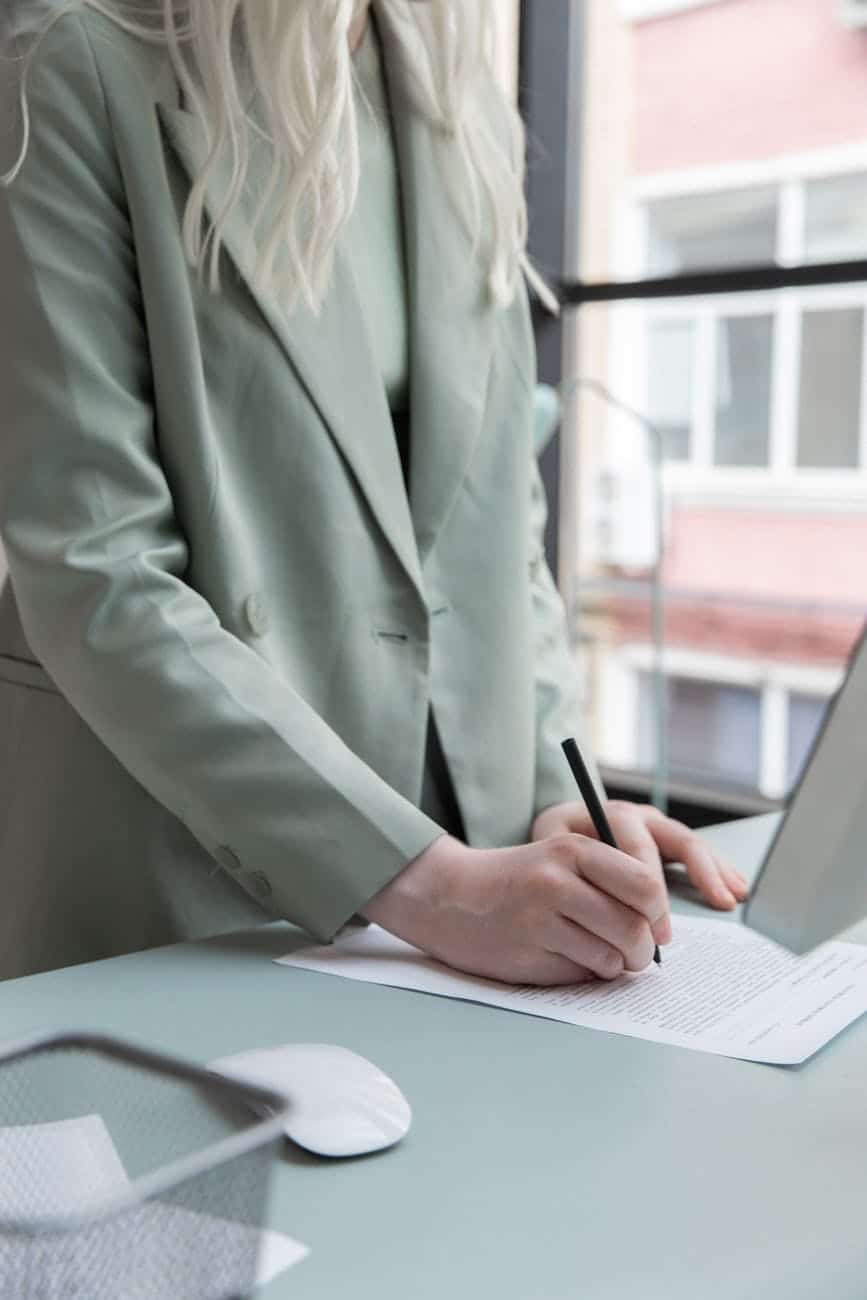crop businesswoman working with documents in office