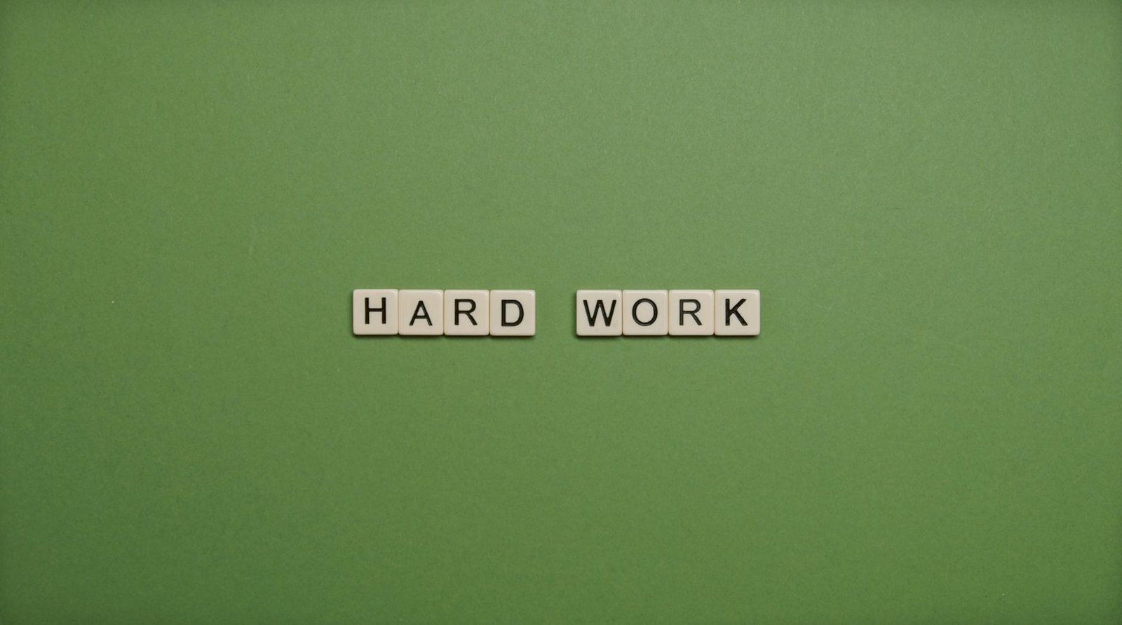hard work text on green background
