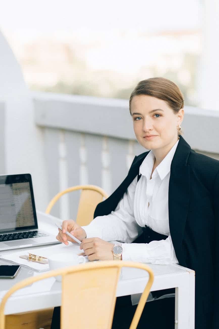 a woman in black blazer sitting on chair