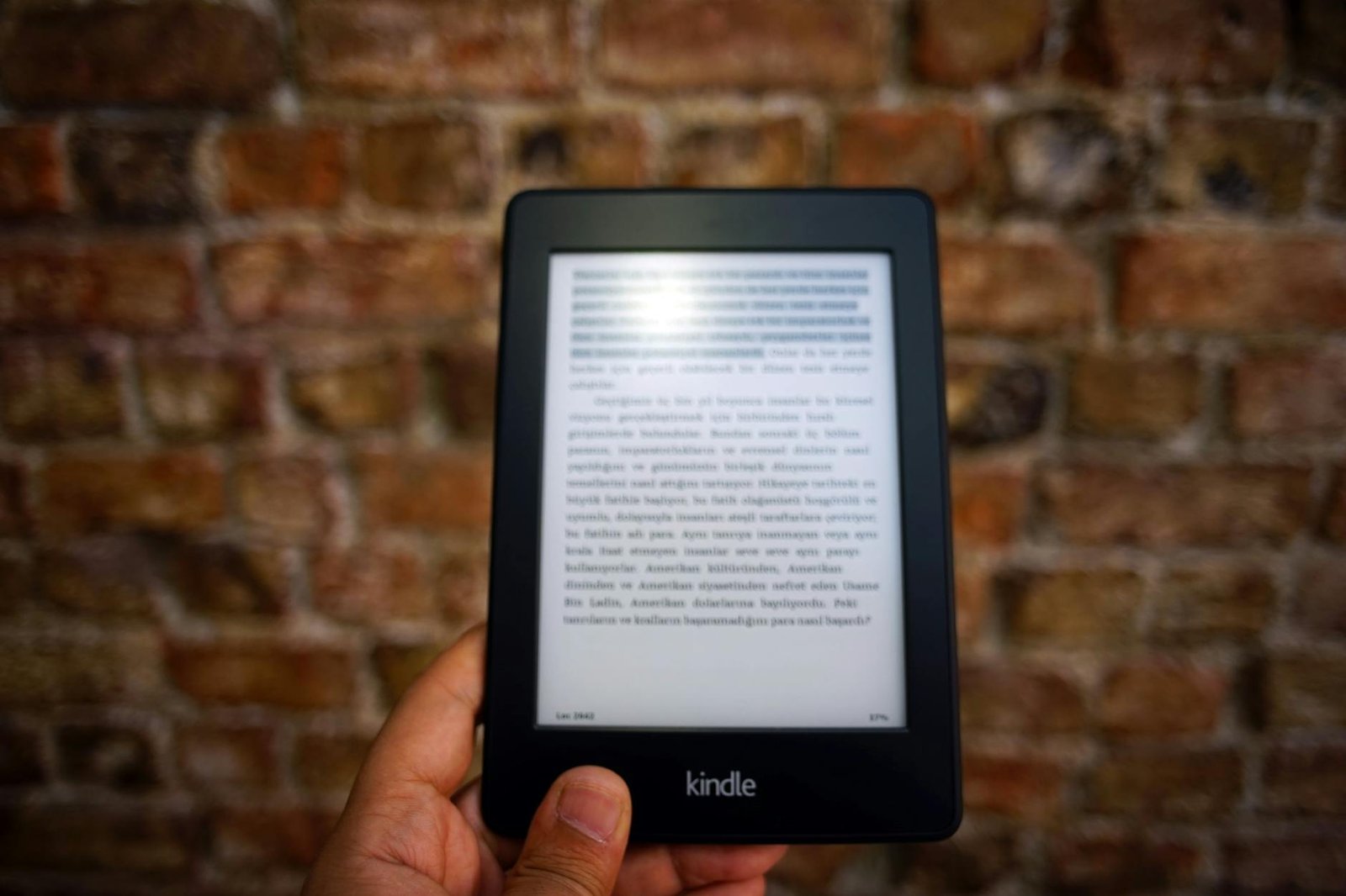 person holding amazon kindle ebook